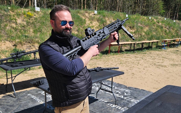 Josef Flek holding MK 24 machine gun on the shooting range